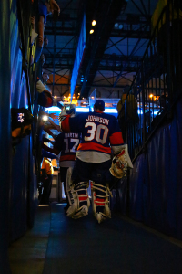 Chad Johnson high fives Islanders fans on his way out to the ice. (Brandon Titus/Inside Hockey)