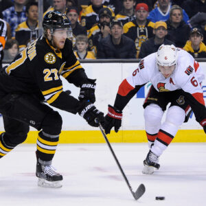 Dec 13, 2014; Boston Bruins defenseman Dougie Hamilton (27) clears the puck in front of Ottawa Senators right wing Bobby Ryan (6) during an NHL game in the TD Garden in Boston. (Photo: Brian Fluharty)