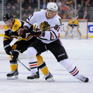 Boston Bruins left wing Daniel Paille (20) and Chicago Blackhawks right wing Marian Hossa (81) battle for the puck.