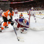 NHL 2015 - Sept 22 - NYR vs PHI - Goalie Magnus Hellberg (#45) of the New York Rangers smothers the puck while playing against Right Wing Wayne Simmonds (#17) of the Philadelphia Flyers
