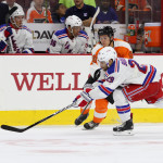 NHL 2015 - Sept 22 - NYR vs PHI - Center Travis Konecny (#80) of the Philadelphia Flyers passes the puck against Left Wing Ryan Bourque (#29) of the New York Rangers