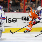 NHL 2015 - Sept 22 - NYR vs PHI - Defenseman Evgeny Medvedev (#82) of the Philadelphia Flyers gets back-checked by Defenseman Brett Bellemore (#39) of the New York Rangers