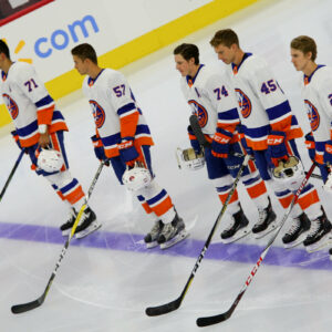 Members of the New York Islanders lineup on the blue line during the national anthem