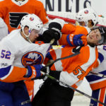 Left Wing Ross Johnston (#52) of the New York Islanders lands a blow against Defenseman Travis Sanheim (#57) of the Philadelphia Flyers