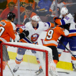 An altercation breaks out between Defenseman Samuel Morin (#50) and Defenseman Mark Friedman (#59) of the Philadelphia Flyers and Left Wing Connor Graham (#17) and Center Matthew Lane (#62) of the New York Islanders