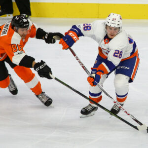 Center Anthony Salinitri (#86) of the Philadelphia Flyers uses his stick to impede Defenseman Sebastian Aho (#28) of the New York Islanders