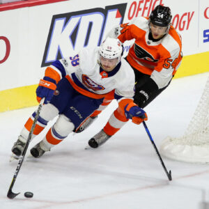 Left Wing Oskar Lindblom (#54) of the Philadelphia Flyers chases Defenseman Mitchell Vande Sompel (#58) of the New York Islanders from behind the net
